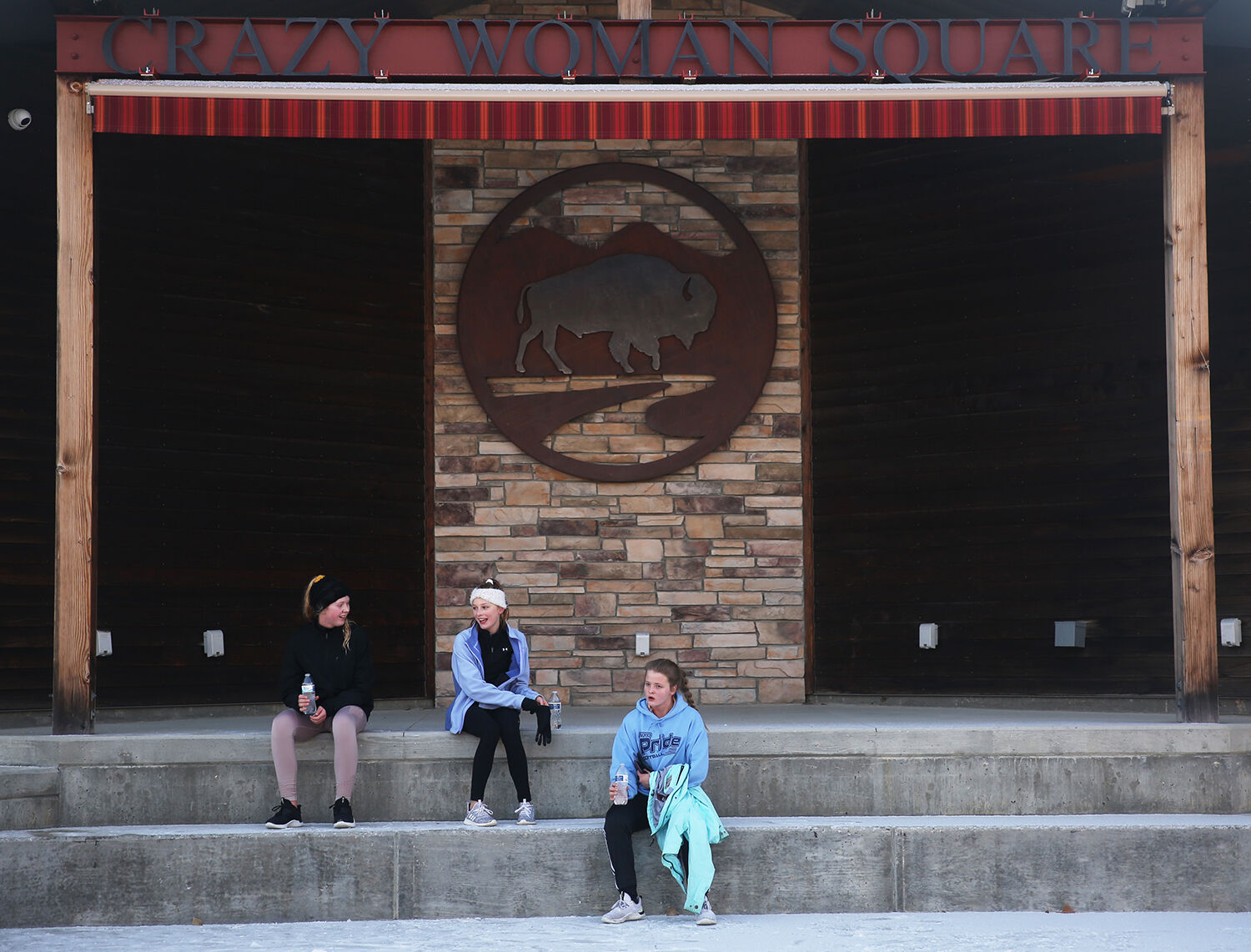 Grace Finkle, Mackenzie Bissett and Izzy Haas relax on the steps